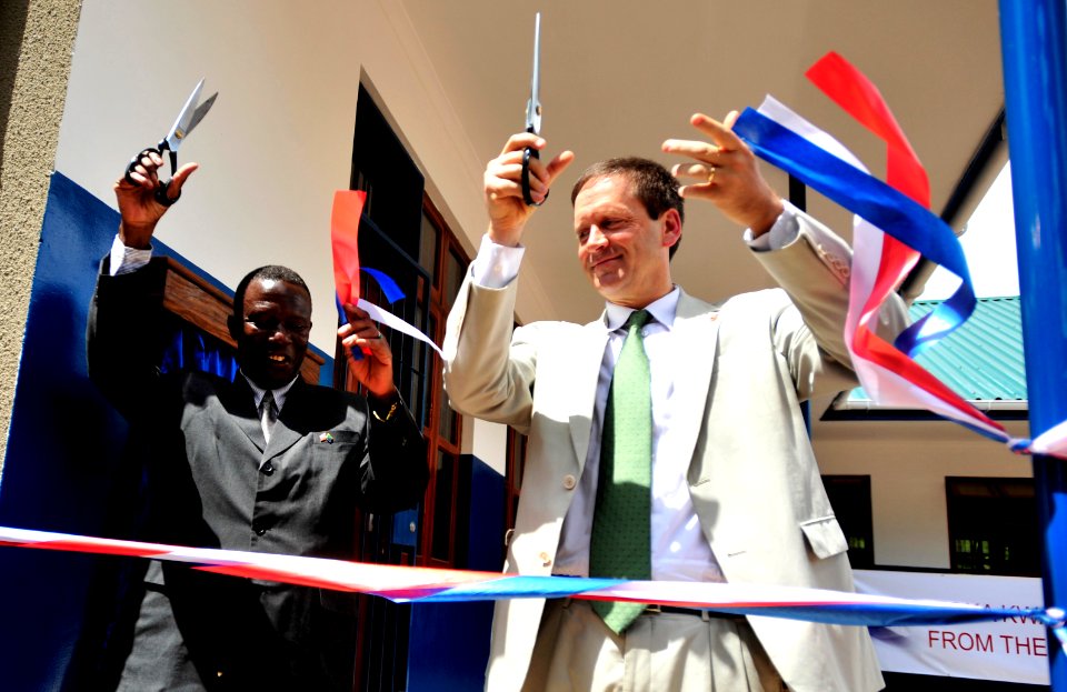 US Navy 081218-N-0506A-061 U.S. Ambassador to Tanzania, Mark Green, cuts a ribbon during a dedication ceremony at Jitegemee Secondary School