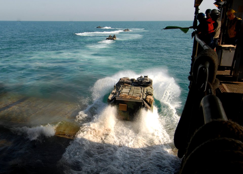 US Navy 081229-N-9134V-062 Amphibious assault vehicles disembark from the well deck of the amphibious dock landing ship USS Carter Hall (LSD 50)