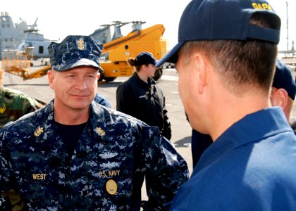 US Navy 081219-N-0803S-004 Master Chief Petty Officer of the Navy (MCPON) Rick West speaks with a Sailor aboard the amphibious assault ship USS Iwo Jima (LHD 7)