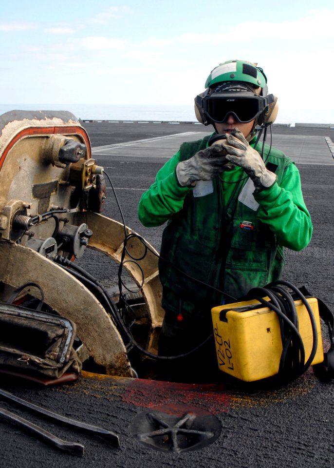 US Navy 081229-N-9900B-006 Aviation Boatswain's Mate (Equipment) Airman Melissa Pyle mans a jet blast deflector station on the flight deck of the aircraft carrier USS Theodore Roosevelt (CVN 71)