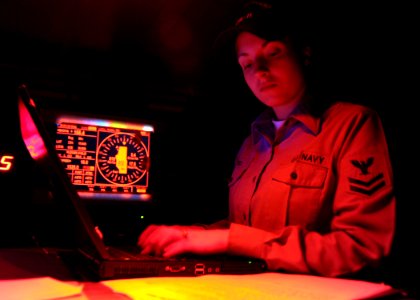 US Navy 090101-N-7571S-002 Quartermaster 2nd Class Kathryn Herd enters the New Year's Day entry in the deck log as the clock strikes midnight aboard the aircraft carrier USS Theodore Roosevelt (CVN 71)