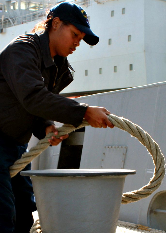 US Navy 090105-N-6764G-028 Seaman Lashaunda Briggs wraps mooring line around a bit