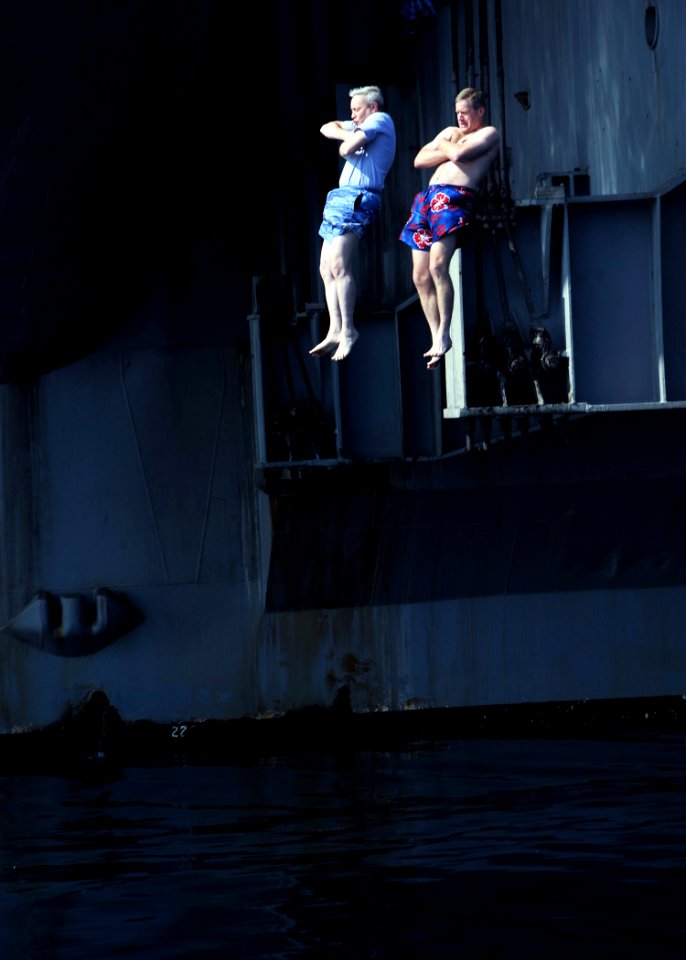 US Navy 090102-N-2908M-004 Capt. Ladd Wheeler, commanding officer of the aircraft carrier USS Theodore Roosevelt (CVN 71), and Capt. Kevin Kovacich, commander, Carrier Air Wing (CVW) 8, jump off the ship at the start of a swim