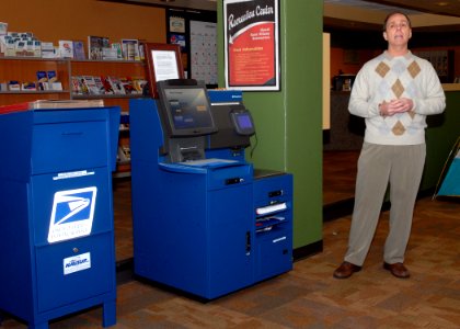 US Navy 090106-N-4649C-002 Rick Buchart explains the features of a new postal kiosk