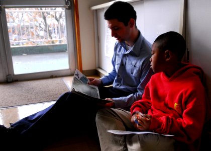 US Navy 090107-N-2013O-011 Gunner's Mate Seaman Shaine Oliver reads to a student at The Sullivans Elementary School at Fleet Activities Yokosuka