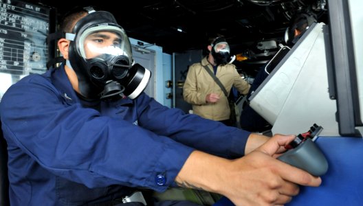 US Navy 110505-N-CP762-162 Gunner's Mate 3rd Class Don Flores operates the MK 38 25 mm gun from the pilot house