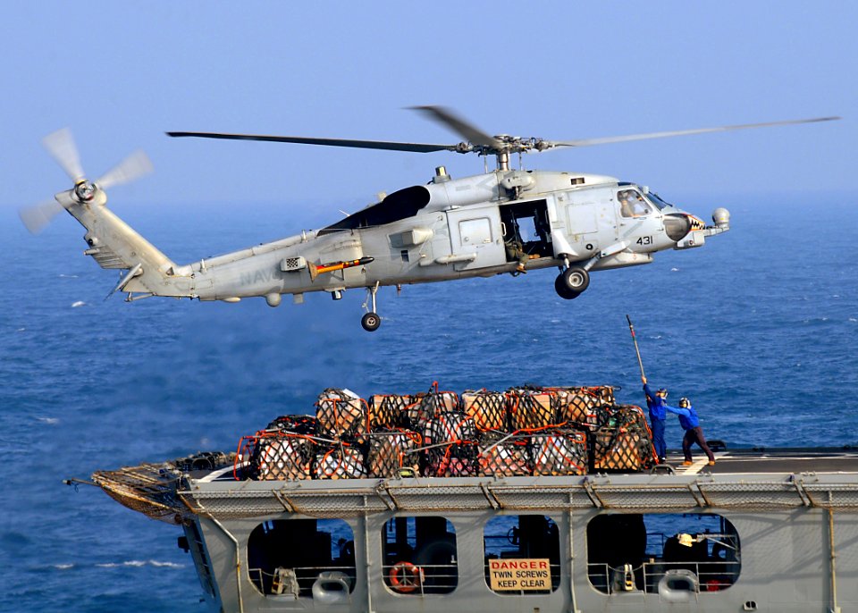 US Navy 081227-N-1082Z-050 An SH-60B Sea Hawk helicopter conducts a vertical replenishment with Military Sealift Command fleet replenishment oiler USNS Tippecanoe (T-AO 199)
