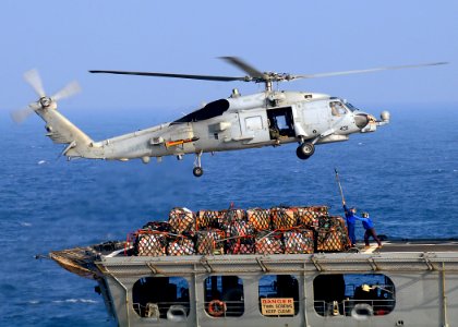 US Navy 081227-N-1082Z-050 An SH-60B Sea Hawk helicopter conducts a vertical replenishment with Military Sealift Command fleet replenishment oiler USNS Tippecanoe (T-AO 199)
