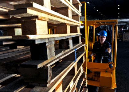 US Navy 090108-N-2908M-004 Storekeeper 3rd Class James Digman shifts pallets in hangar bay three aboard USS Theodore Roosevelt (CVN 71)