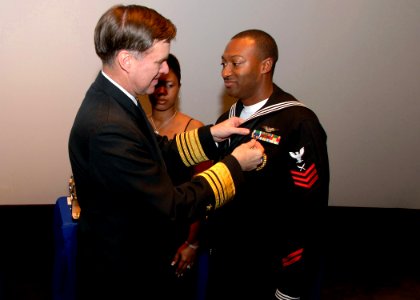 US Navy 090107-N-7948R-052 Vice Adm. Mark E. Ferguson, III presents the Navy-Marine Corps Commendation Medal to Yeoman 1st Class Kelsey Deriso