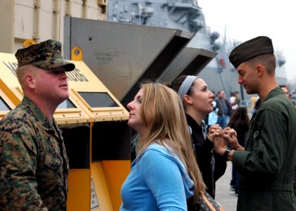 US Navy 090109-N-6410J-023 Two Marines spend time with their loved ones prior to boarding USS Boxer (LHD 4) for deployment