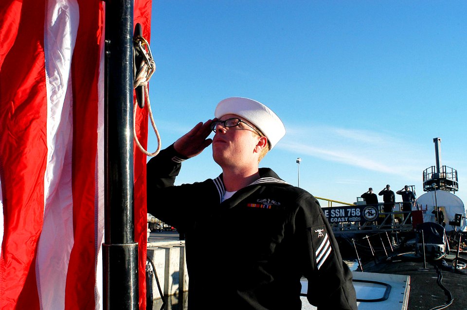 US Navy 090111-N-9421C-022 Fire Control Technician Seaman Jerimiah Hendry, from Kenosha, Wis., salutes the national ensign during morning colors