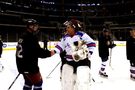 US Navy 090108-N-3659B-528 Command Master Chief Mark Rudes, a goalie for the Ronald Reagan Hockey Team, shakes hands with opposing players