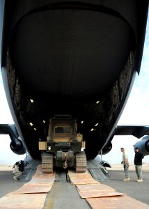 US Navy 090109-N-1120L-006 Seabees and Air Force airmen marshal a Seabee bulldozer into an Air Force C-17