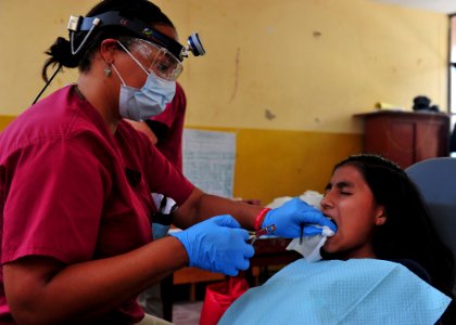 US Navy 110501-N-QD416-150 Dr. Kimberley Gise extracts a tooth during a Continuing Promise 2011 medical community service project photo
