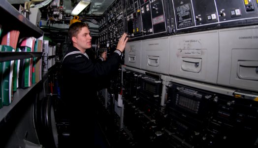 US Navy 090112-N-7705S-081 Machinist's Mate 3rd Class Michael Petersohn, from Tacoma, Wash., checks the controls after demonstrating the pressurization of a torpedo tube aboard the Los Angeles-class fast-attack submarine USS Bo