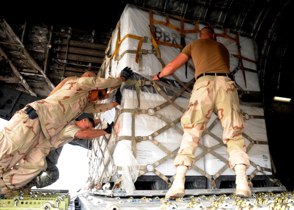 US Navy 090109-N-1120L-075 Seabees and Air Force airmen maneuver 463L pallets into an Air Force C-17 aircraft