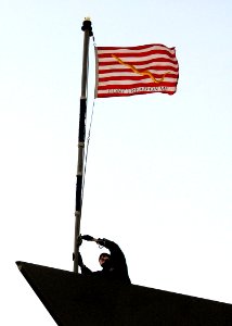 US Navy 090114-N-0780F-006 A Sailor hoists the Navy Jack as the Oliver Hazard Perry-class guided-missile frigate USS Taylor (FFG 50) arrives in Souda Bay photo