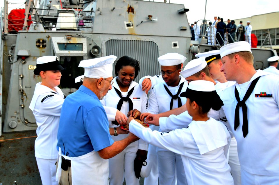 US Navy 110430-N-PS473-102 Sailors reach for a cookie from Art Ginsburg aboard SS Ross (DDG 71) during the taping of a Salute to the Troops segment