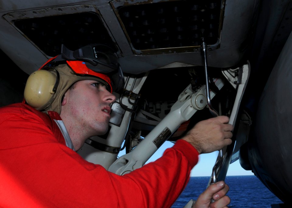 US Navy 090109-N-4014G-026 Aviation Ordnanceman 3rd Class Walter Robbins works on an F-A-18F Super Hornet