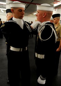 US Navy 090108-N-7948R-006 ailors assigned to the U.S. Navy Ceremonial Guard headquarters help each other prepare for a uniform inspection