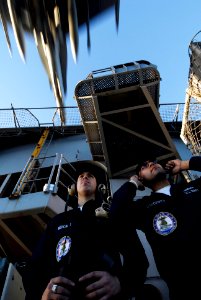 US Navy 090117-N-8157C-147 Boatswain's Mate Seaman Guillermo Mercado, left, from Reading, Pa., and Seaman Chris Cardenas, from Ft. Worth, Texas, stand aft lookout watch on the fantail of the aircraft carrier USS John C. Stennis