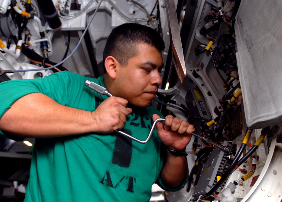 US Navy 090113-N-2456S-006 Aviation Electronics Technician Airman William Vasquez removes an instrument landing system receiver from an F-A-18F Super Hornet