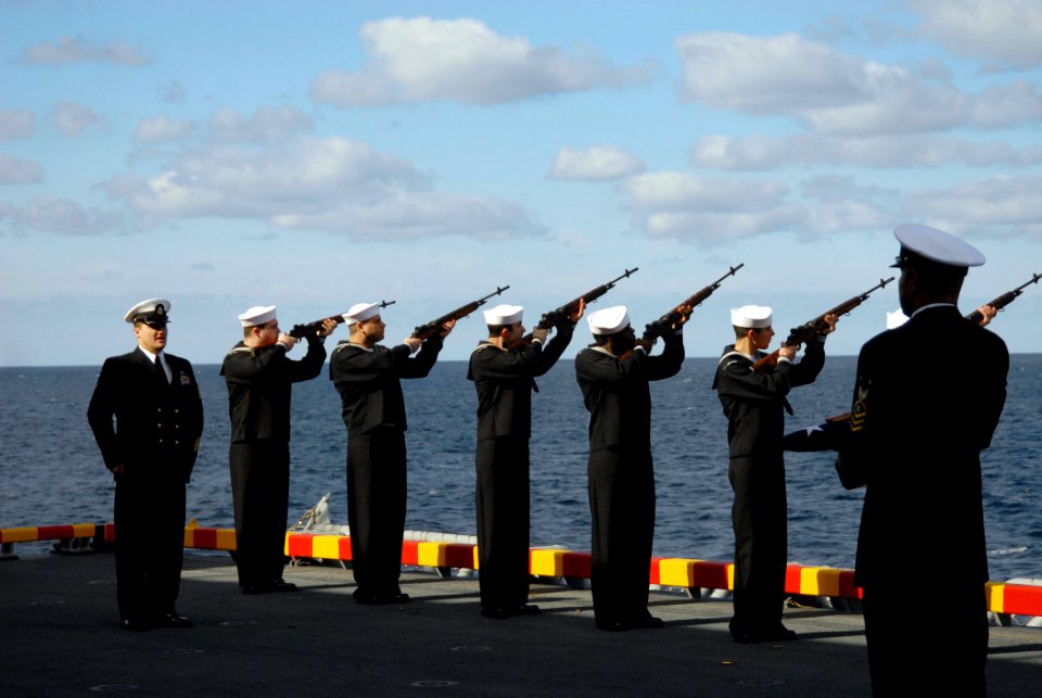 US Navy 090110-N-2439G-085 Sailors aboard the amphibious assault ship USS Wasp (LHD 1) fire a rifle volley during a burial at sea. Twelve former service members were interned during the ceremony off the coast of North Carolina