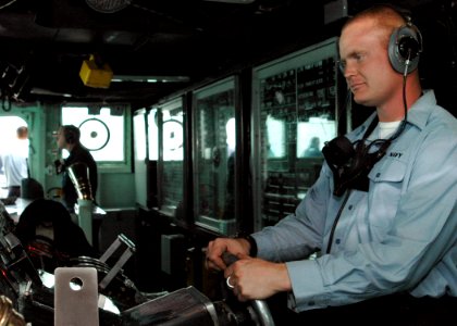 US Navy 090117-N-9134V-030 Seaman Shawn Fritz, from Ashtabula, Ohio, mans the helm aboard the amphibious dock landing ship USS Carter Hall (LSD 50)
