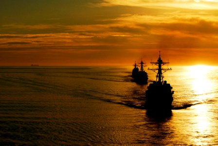 US Navy 090120-N-6538W-106 The guided-missile destroyers USS Kidd (DDG 100), front, and USS Preble (DDG 88) steam ahead of the guided-missile cruiser USS Antietam (CG 54) during a sunrise photographic exercise