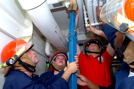 US Navy 090119-N-3931M-083 Sailors from USS Mason (DDG 87) shore a water-tight hatch photo