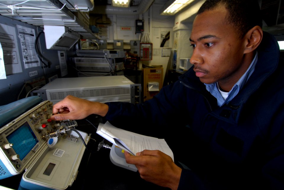 US Navy 090116-N-3946H-004 Aviation Electronics Technician 3rd Class Tony Jackson calibrates an oscilloscope in the aircraft intermediate maintenance department calibration laboratory aboard the aircraft carrier USS Nimitz (CVN