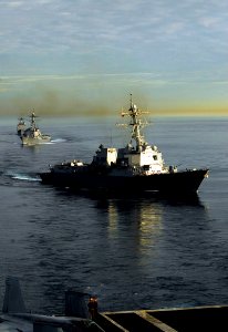 US Navy 090120-N-6538W-183 The guided-missile destroyers USS Kidd (DDG 100), front, and USS Preble (DDG 88) steam ahead of the guided-missile cruiser USS Antietam (CG 54) during a sunrise photographic exercise