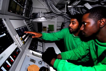 US Navy 090121-N-9610C-030 Interior Communications Electrician 3rd Class John Cummings, left, from Augusta, Ga., trains Interior Communications Electrician 3rd Class Joshua Aziz, from Los Angeles, to operate the visual landing