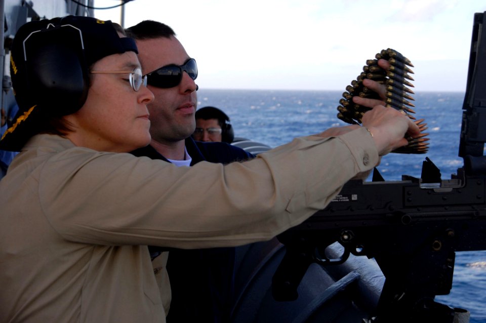 US Navy 090119-N-1688B-300 Capt. Cindy Thebaud, commander, Africa Partnership Station (APS) 2009, receives training on the M-240 machine gun while aboard the amphibious transport dock ship USS Nashville (LPD 13)