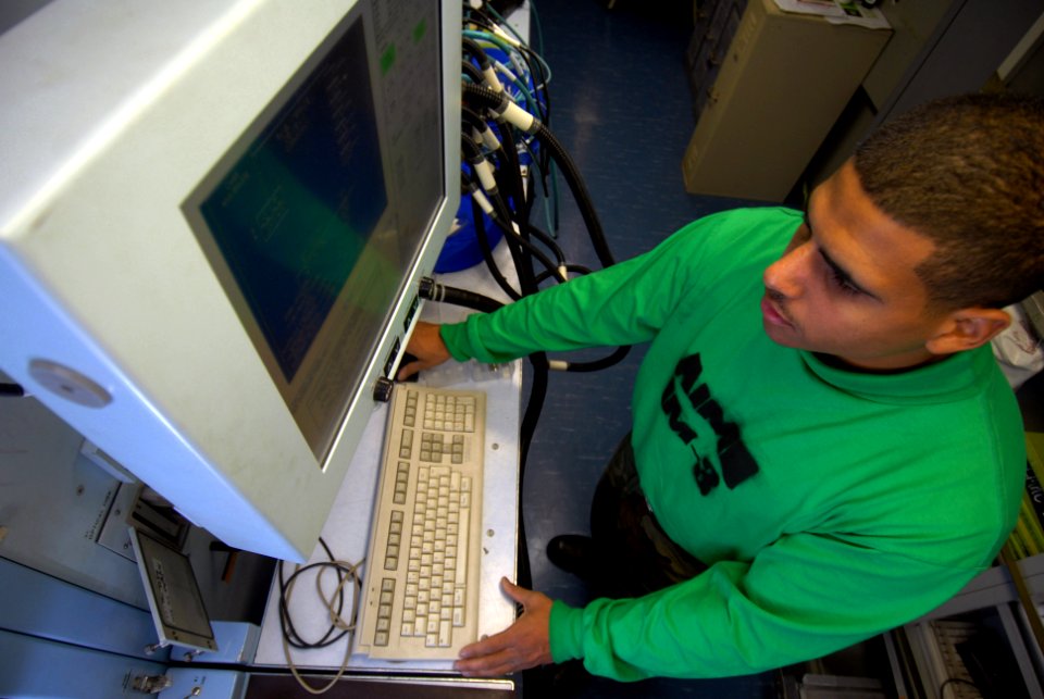 US Navy 090123-N-3946H-050 Aviation Electronics Technician Airman Anthony Camacho works on a consolidated automated support system