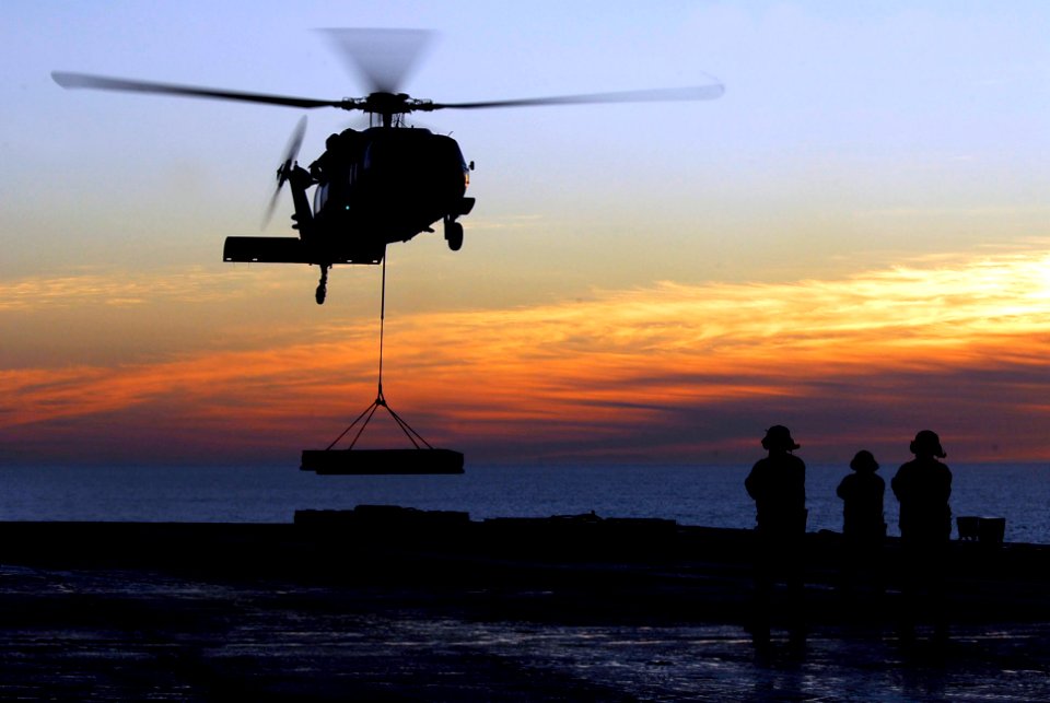 US Navy 090118-N-6538W-125 Sailors aboard the aircraft carrier USS John C. Stennis (CVN 74) watch as an MH-60S Sea Hawk helicopter from the