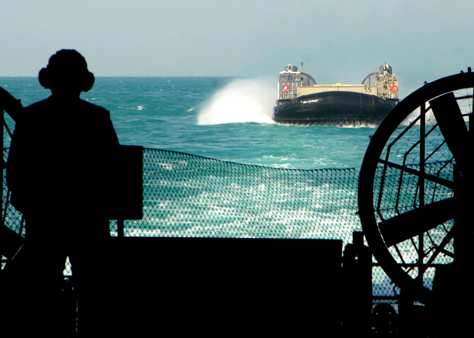 US Navy 090119-N-3392P-003 Command Master Chief Don Ouellette observes a landing craft air cushion approach the amphibious dock landing ship USS Carter Hall (LSD 50)
