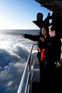 US Navy 090123-N-9610C-054 Seaman Brittany Larsen, from Arcata, Calif., trains Seaman Elizabeth Aceto, from Boston, on the duties of the aft starboard look out watch