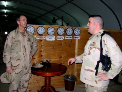 US Navy 090120-N-1469M-019 Chief Personnel Specialist Kourtney Salt discusses administrative in-processing procedures for individual augmentees with Adm. Jonathan W. Greenert