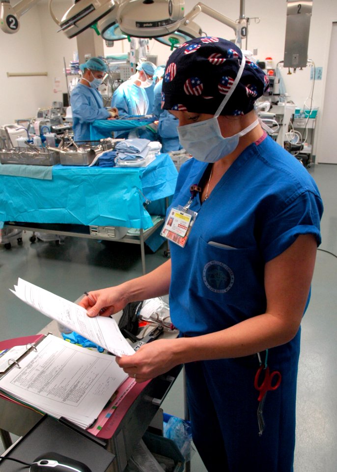 US Navy 090121-N-6326B-103 Melissa Canedo scans the World Health Organization (WHO) Surgical Check List before proceeding to the next phase in the operating procedure