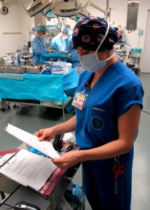 US Navy 090121-N-6326B-103 Melissa Canedo scans the World Health Organization (WHO) Surgical Check List before proceeding to the next phase in the operating procedure