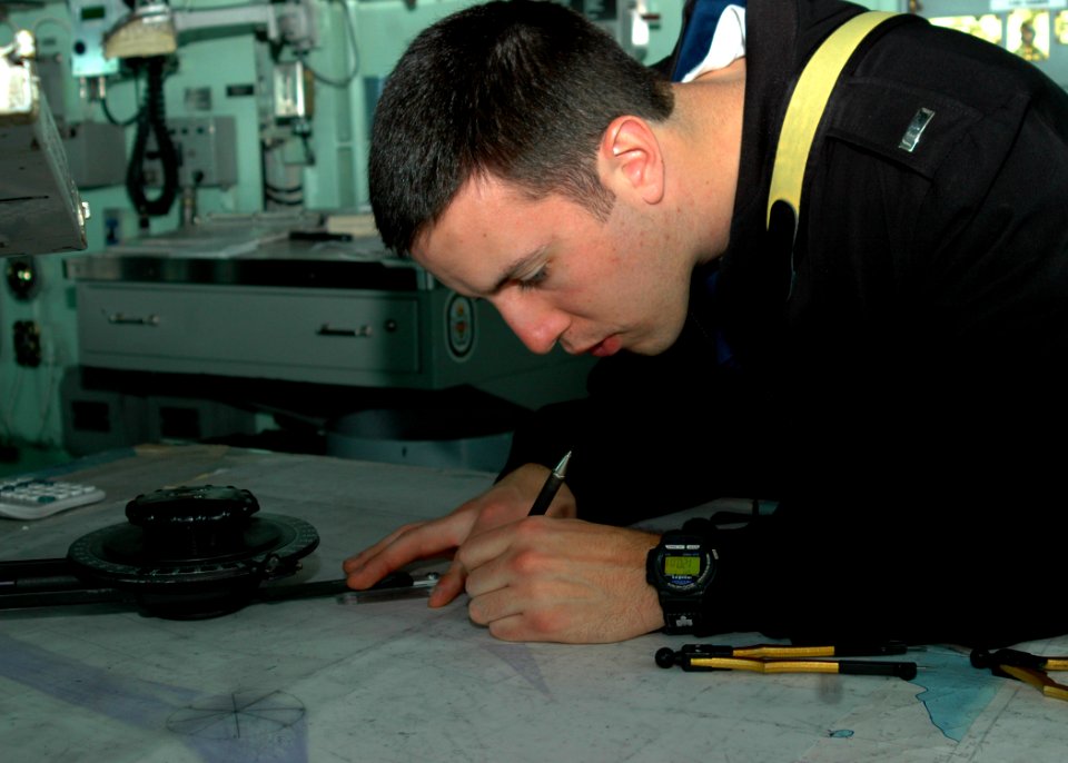 US Navy 090117-N-9134V-026 Lt. j.g. John Horwath, from Berwyn, Ill., plots a course on a navigation chart aboard the amphibious dock landing ship USS Carter Hall (LSD 50)