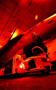US Navy 090122-N-6538W-051 Aviation Boatswain's Mate (Handling) Airman Natasha Greely, from Stafford, Va., uses a spotting dolly to maneuver an F-A-18C Hornet assigned to the