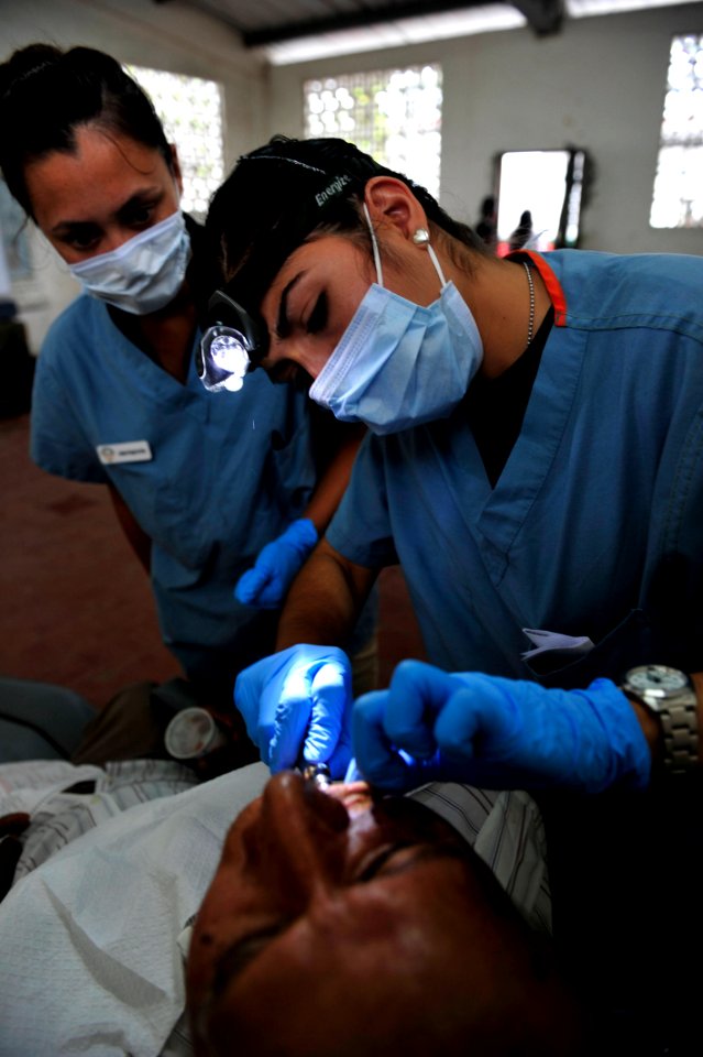 US Navy 110608-F-NJ219-057 Lt. Laura Quintana, right, performs a tooth extraction as Jessica Vergel De Dios observes
