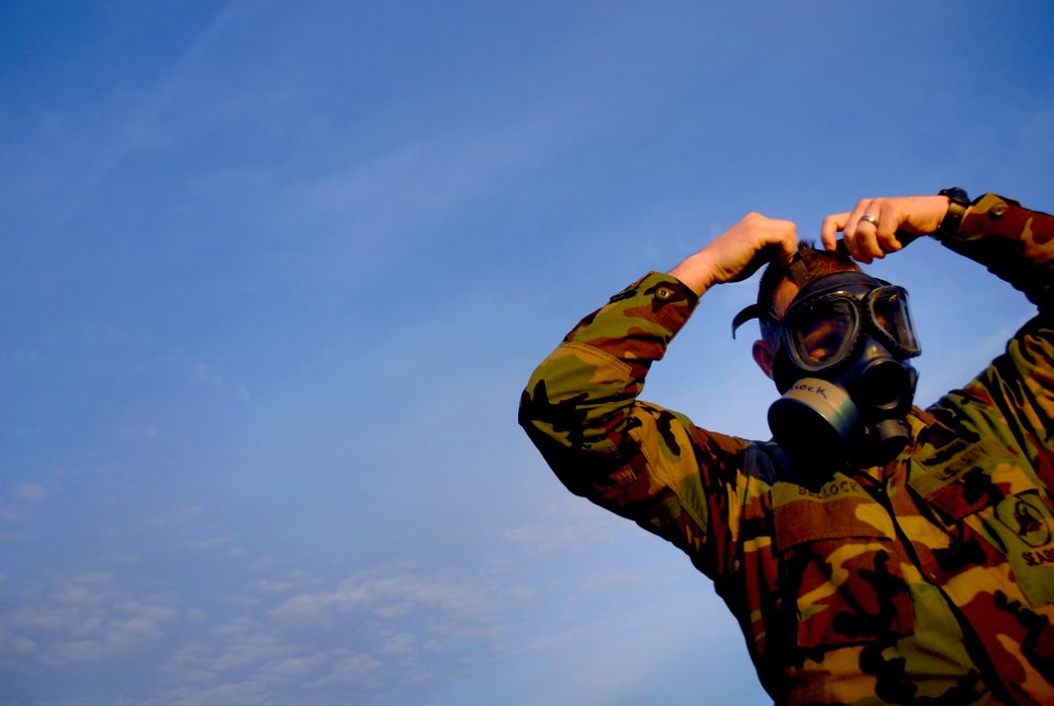 US Navy 090123-N-3674H-073 Storekeeper 1st Class Richard Bellock, assigned to Naval Mobile Construction Battalion (NMCB) 74, dons a MCU-2P gas mask during a chemical, biological and radiological exercise