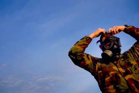 US Navy 090123-N-3674H-073 Storekeeper 1st Class Richard Bellock, assigned to Naval Mobile Construction Battalion (NMCB) 74, dons a MCU-2P gas mask during a chemical, biological and radiological exercise