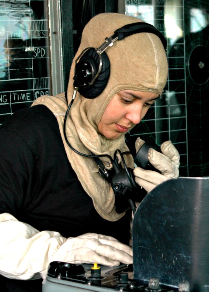US Navy 090122-N-9134V-038 Operations Specialist Seaman Kimberly Pagan, from Brooklyn, N.Y., communicates with the combat information center during a general quarters drill aboard the amphibious dock landing ship USS Carter Hal