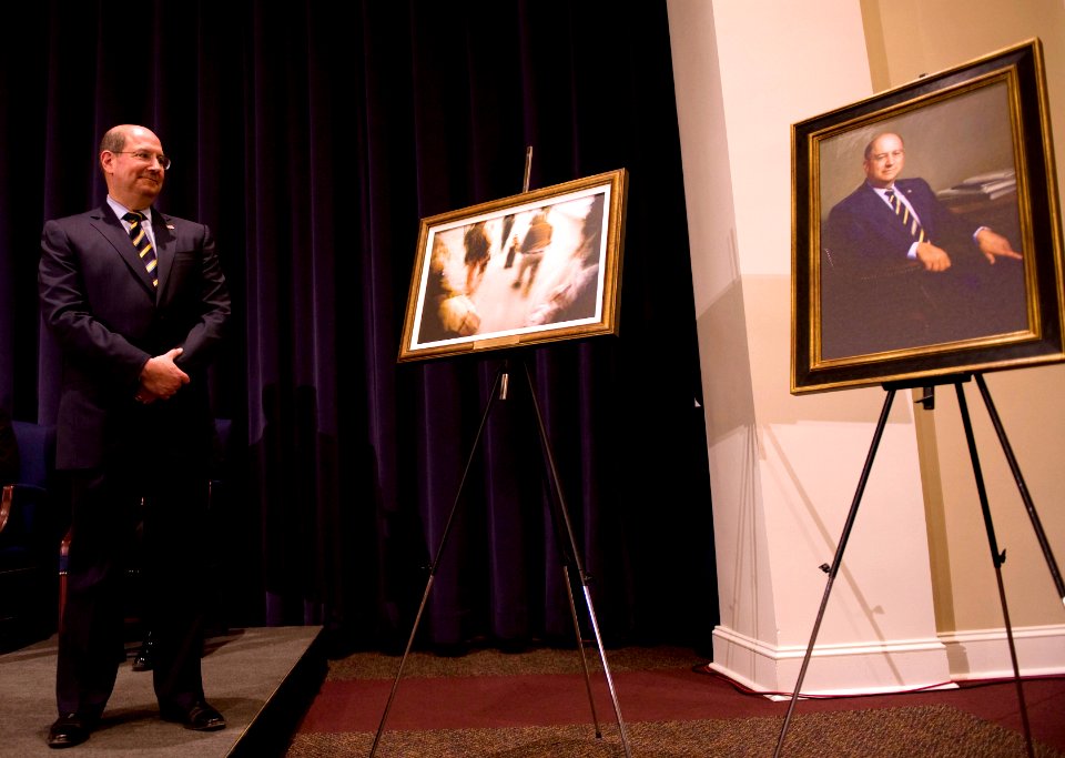 US Navy 090123-N-7090S-275 Secretary of the Navy (SECNAV) the Honorable Dr. Donald C. Winter looks over paintings presented to him during his farewell ceremony at the Marine Barracks at 8th and I Streets