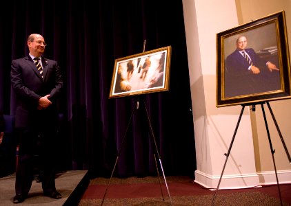 US Navy 090123-N-7090S-275 Secretary of the Navy (SECNAV) the Honorable Dr. Donald C. Winter looks over paintings presented to him during his farewell ceremony at the Marine Barracks at 8th and I Streets